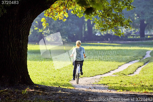 Image of Woman on the bicycle in park