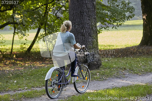 Image of Woman on the bicycle in park