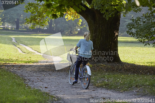 Image of Woman on the bicycle in park