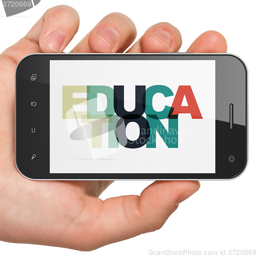 Image of Education concept: Hand Holding Smartphone with Education on  display
