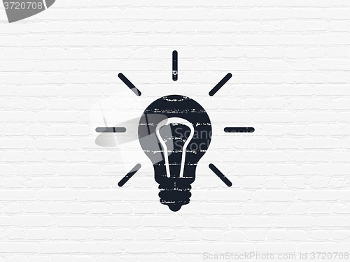 Image of Finance concept: Light Bulb on wall background