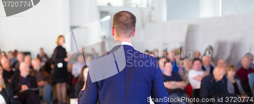 Image of Speaker at Business Conference and Presentation.