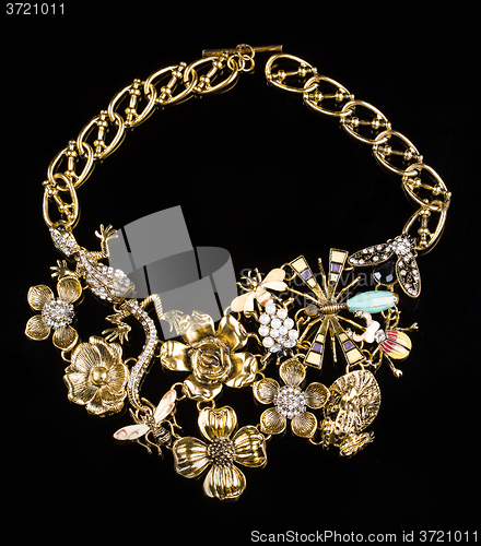 Image of luxury necklace of plastic flowers on black stand