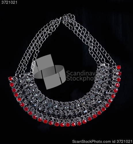 Image of luxury red necklace on black stand