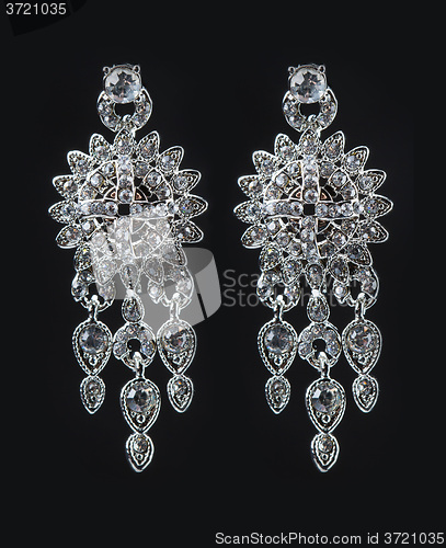 Image of earrings with jewels on the black