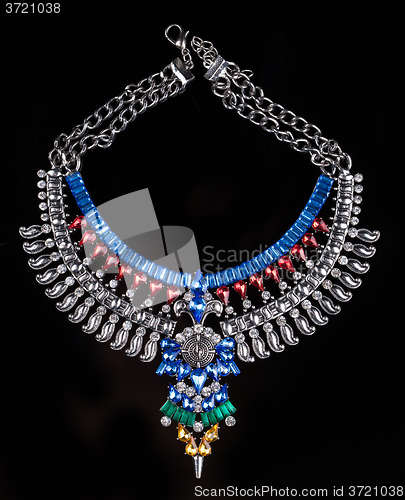 Image of metal necklace with red and blue stones