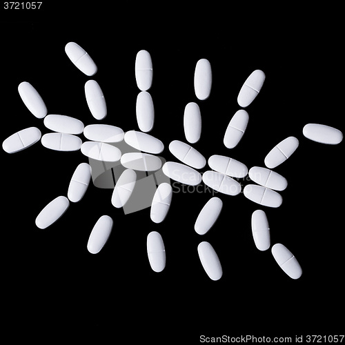 Image of White pills on the black