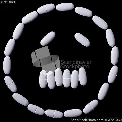 Image of White pills on the black