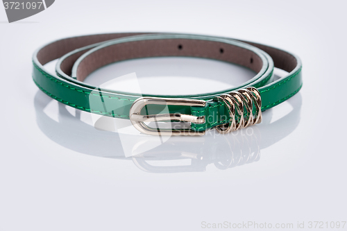 Image of thin green female belt buckle with fine