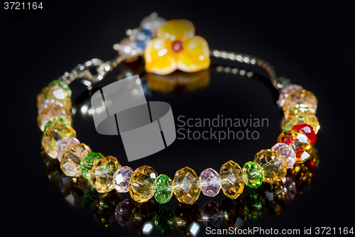 Image of beautiful plastic bracelet on black background. 