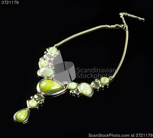 Image of luxury green necklace on black stand