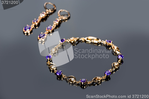 Image of gold bracelet on gray background. 