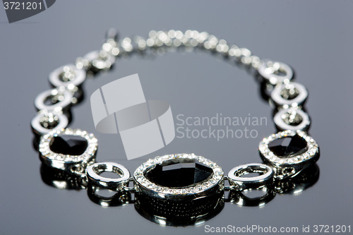 Image of beautiful bracelet on gray background. 