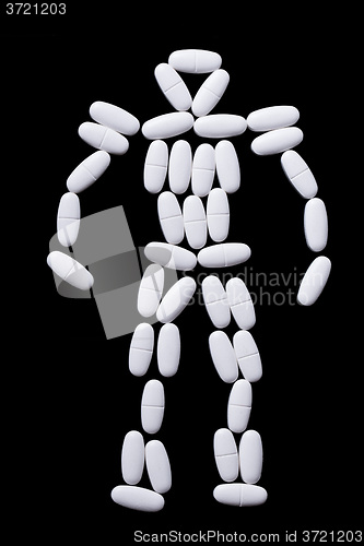 Image of White pills on the black