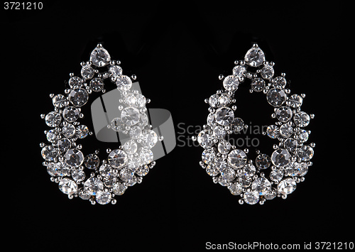 Image of earrings with jewels on the black