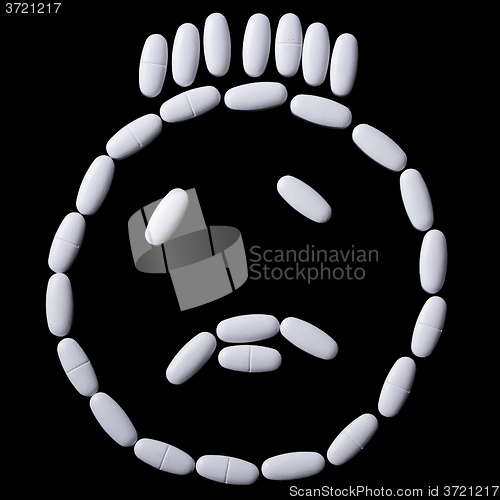 Image of White pills on the black