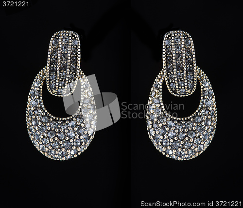 Image of earrings with jewels on the black