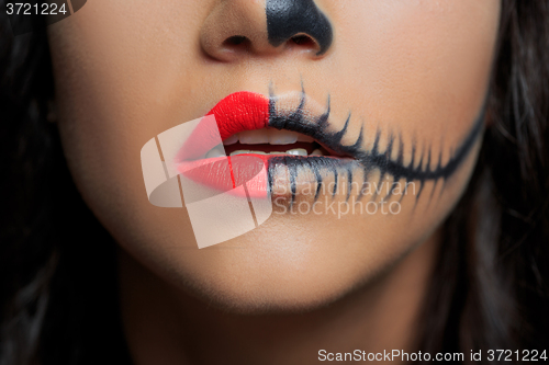 Image of beautiful woman with make-up skeleton