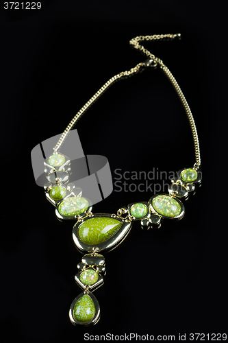 Image of luxury green necklace on black stand