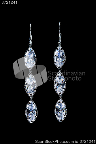 Image of earrings with jewels on the black