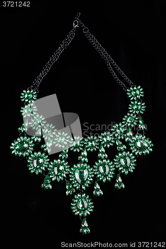 Image of luxury green necklace on black stand
