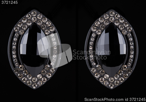 Image of earrings with jewels on the black