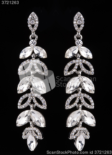 Image of earrings with jewels on the black