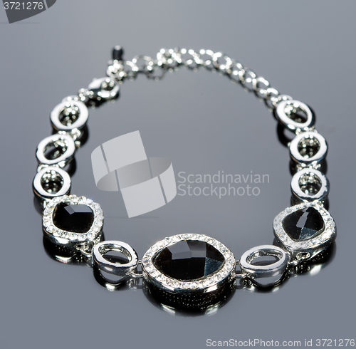 Image of beautiful bracelet on gray background. 