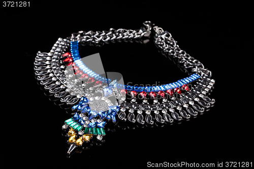 Image of metal necklace with red and blue stones
