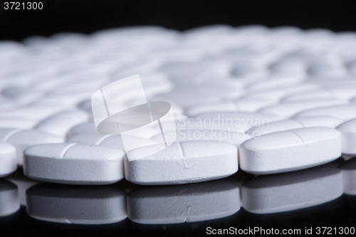 Image of White pills on the black