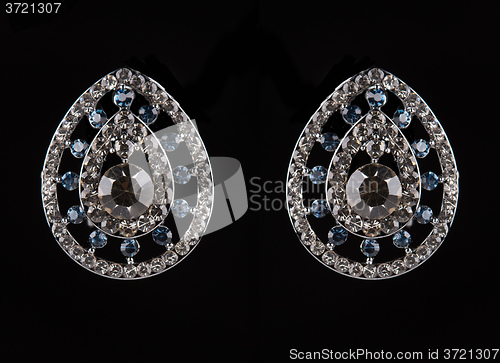 Image of earrings with jewels on the black