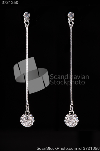 Image of earrings with jewels on the black