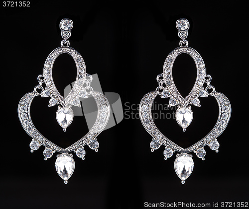 Image of earrings with jewels on the black