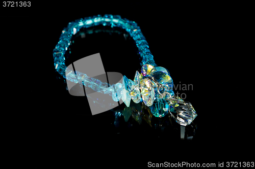 Image of beautiful blue plastic bracelet on black background. 