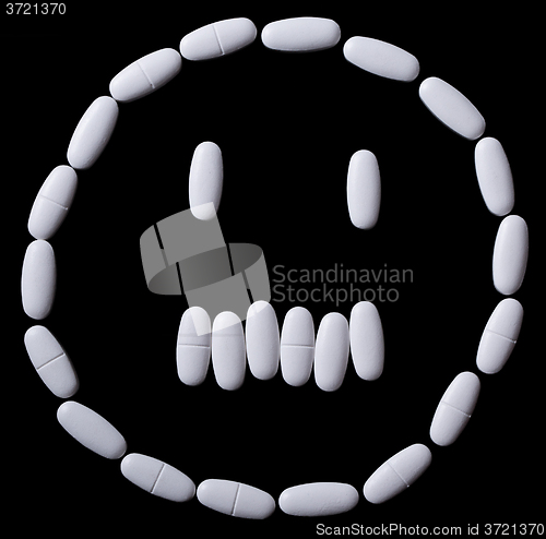 Image of White pills on the black