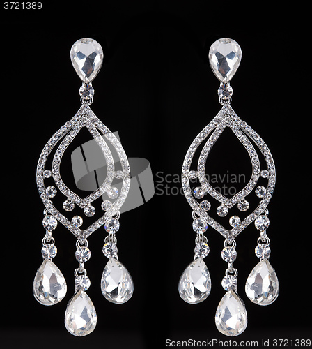 Image of earrings with jewels on the black