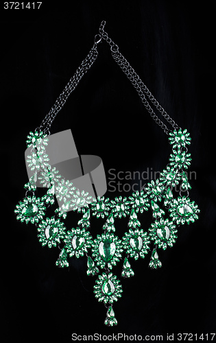 Image of luxury green necklace on black stand