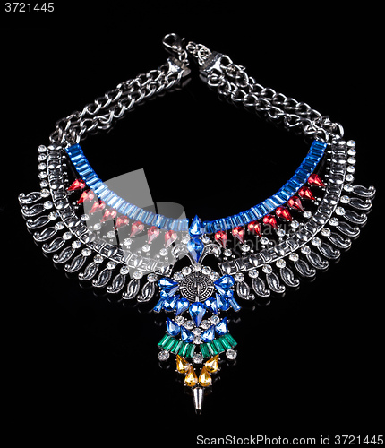 Image of metal necklace with red and blue stones