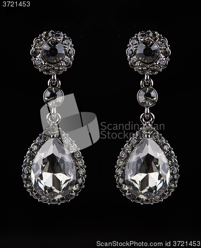 Image of earrings with jewels on the black
