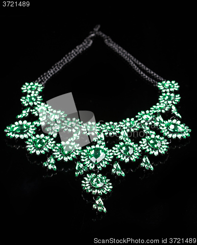 Image of luxury green necklace on black stand