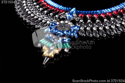 Image of metal necklace with red and blue stones