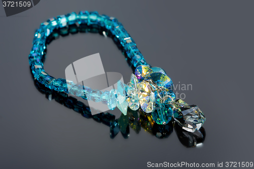 Image of beautiful blue bracelet on gray background. 