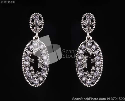 Image of earrings with jewels on the black