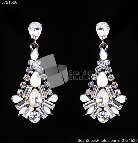 Image of earrings with jewels on the black