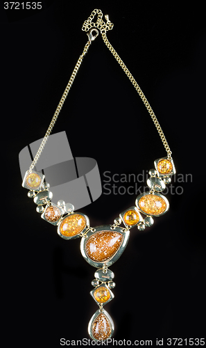 Image of luxury yellow necklace on black stand