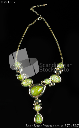 Image of luxury green necklace on black stand