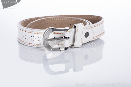 Image of thin white female belt buckle with fine