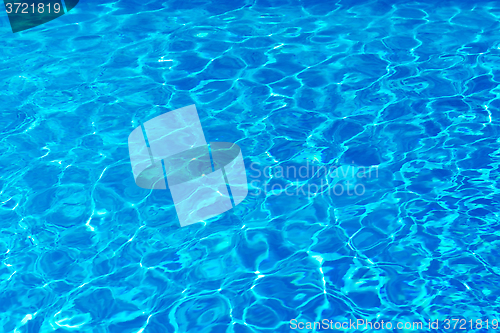Image of Blue pool water with sun reflections.