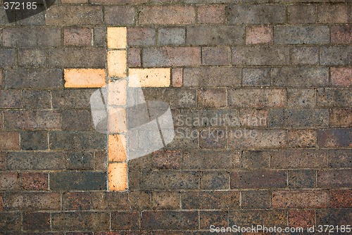 Image of cross of christ built into a brick wall