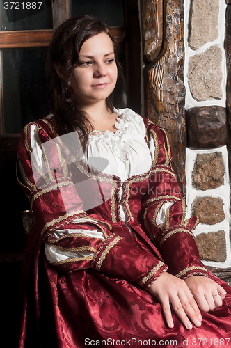 Image of Pretty woman in red dress in retro baroque style